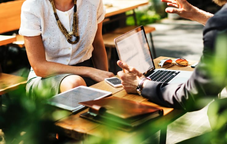 two people having a meeting outdoors